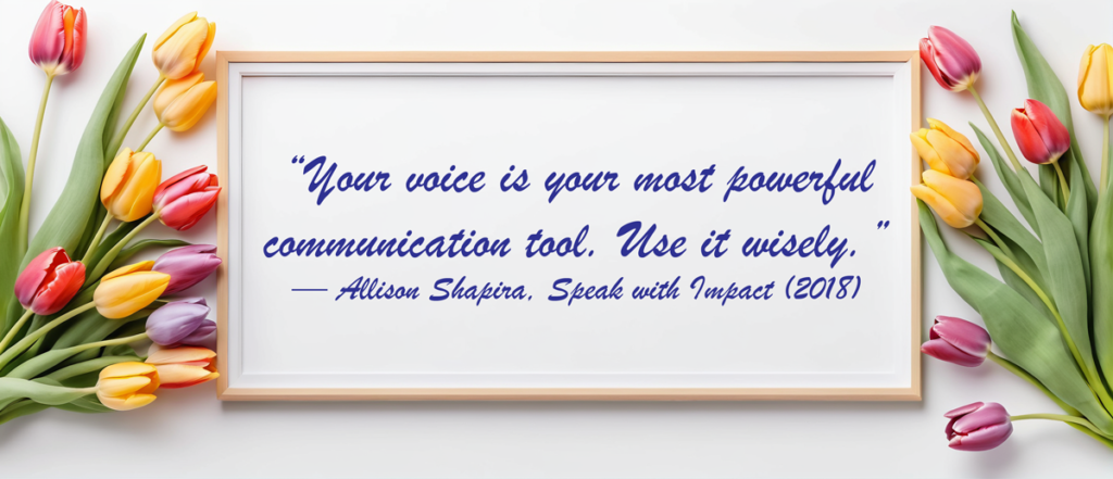 Quote by Allison Shapira: 'Your voice is your most powerful communication tool. Use it wisely.' on a whiteboard background framed in wood, surrounded by multicolored tulips.